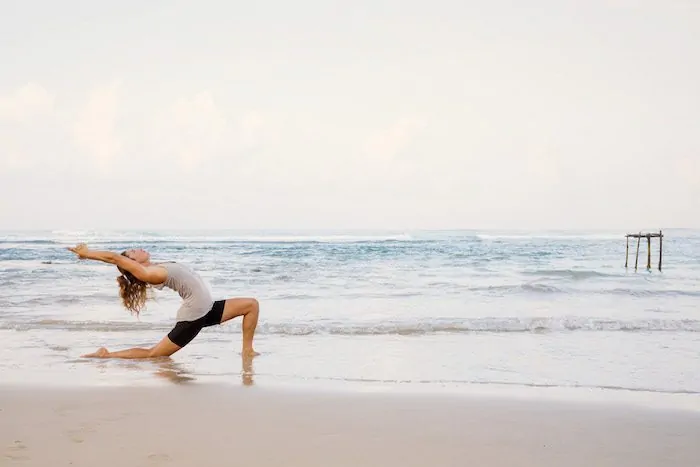 yoga on the beach - crescent moon pose - lucy foster perkins