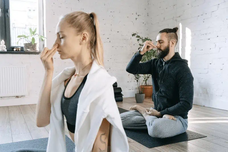 Pranayama practices such as Nadi Shodhana (alternate nostril breathing, shown here), help balance the energies of the body.