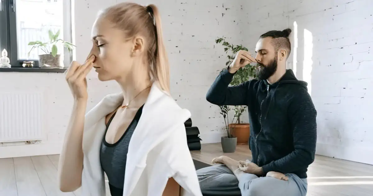 Pranayama Power, woman and a man sitting on yoga mat practicing pranayama breathing techniques