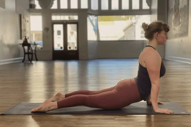 In Upward Facing dog, keep the thighs lifted and engage the shoulders.