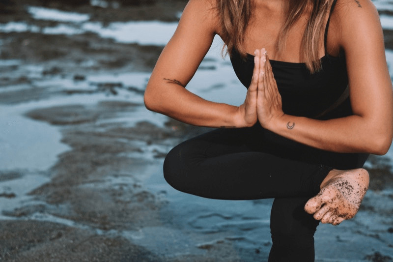 In the FIgure Four variation of Chair Pose, cross one ankle over your opposite thigh to build strength and stability.