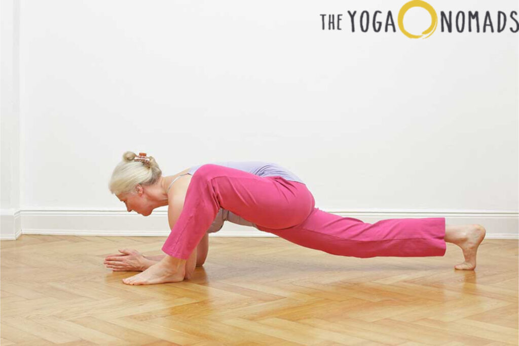 3 Yin Yoga Poses for Deep Joint Relief yin yoga poses 2 The image shows a person sitting cross-legged on a yoga mat in a bright and peaceful indoor space. They are dressed in a white top and dark leggings, with their hands resting gently on their knees in a meditative posture. The background features soft natural lighting and indoor plants, creating a serene atmosphere that promotes mindfulness and relaxation through yoga practice.