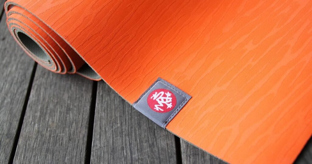 this is a featured image for an article on best yoga mats for sensitive joints. It featured a yog amat with a logo on it.